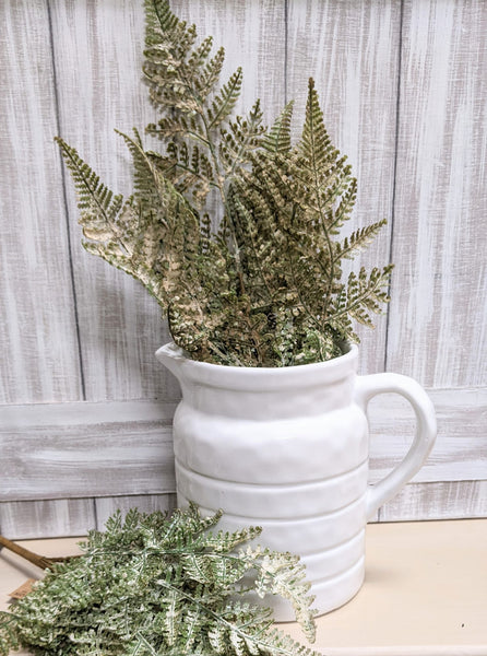 white ceramic pitcher  wood fern stem